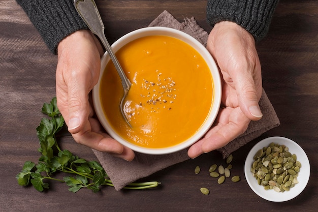 Free photo close-up hands holding bowl