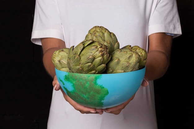 Free photo close-up hands holding bowl