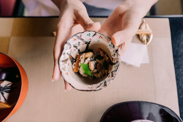 Close up hands holding bowl