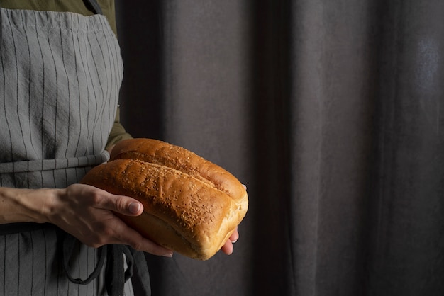 Free photo close up hands holding bread