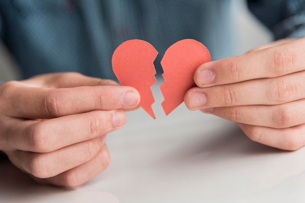 Close-up hands holding broken heart