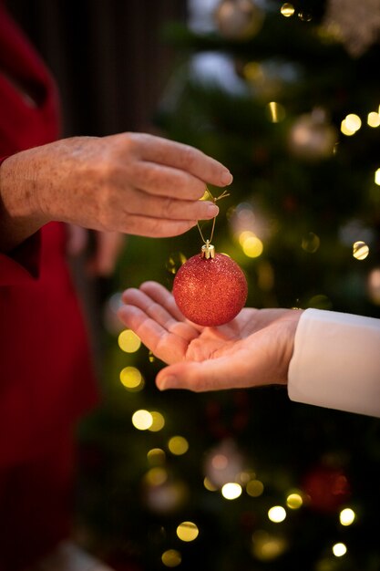 Close-up hands holding christmas ball