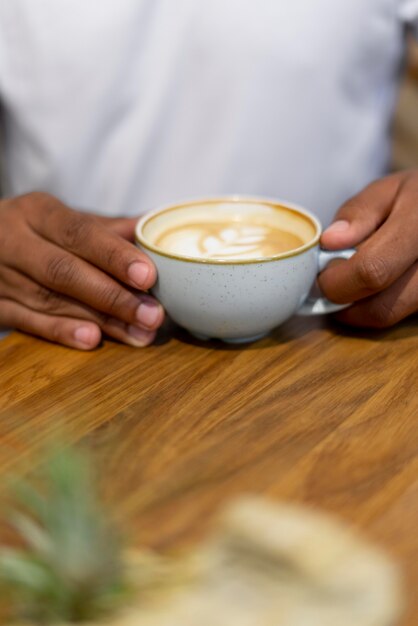 Close up hands holding coffee cup
