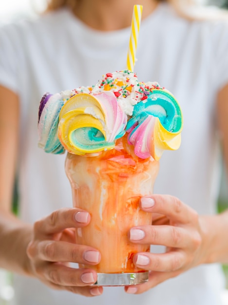 Close-up hands holding colorful shake