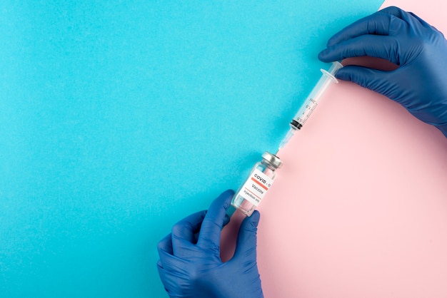 Close up hands holding coronavirus vaccine