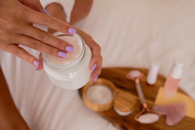 Close up hands holding cream container