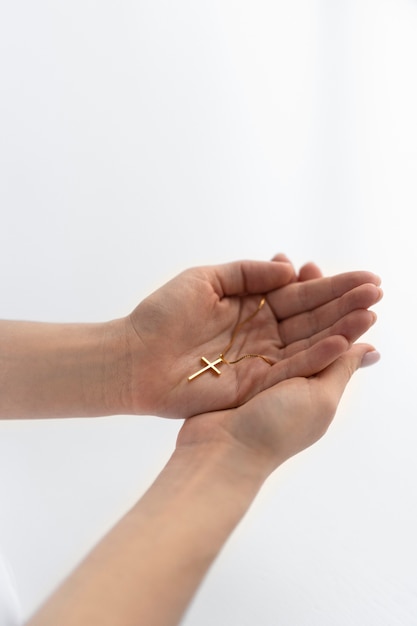 Close up hands holding crucifix