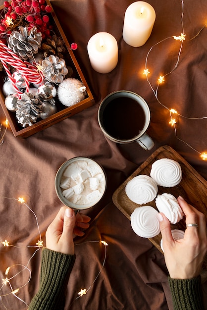 Close up hands holding cup and cookie