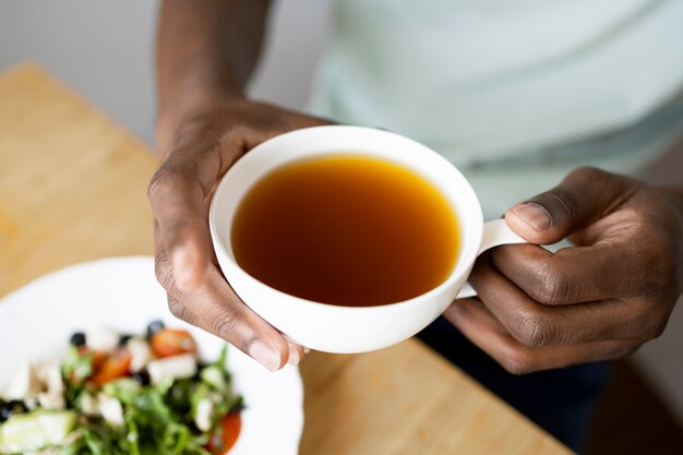 Close up hands holding cup