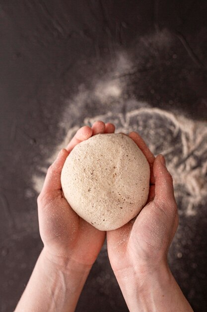 Close-up hands holding dough