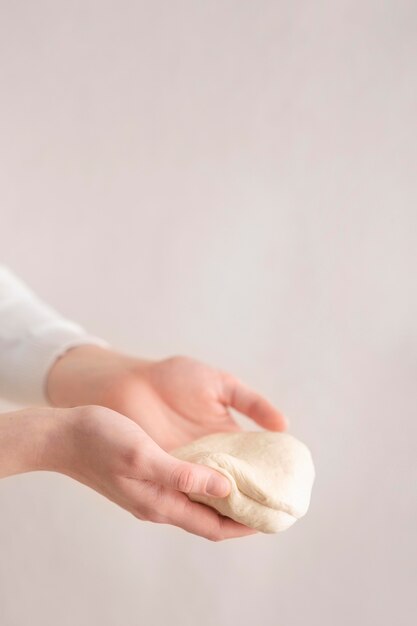 Close-up hands holding dough