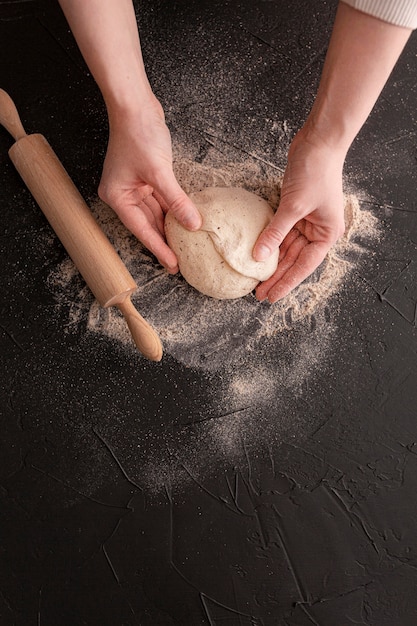 Free photo close-up hands holding dough