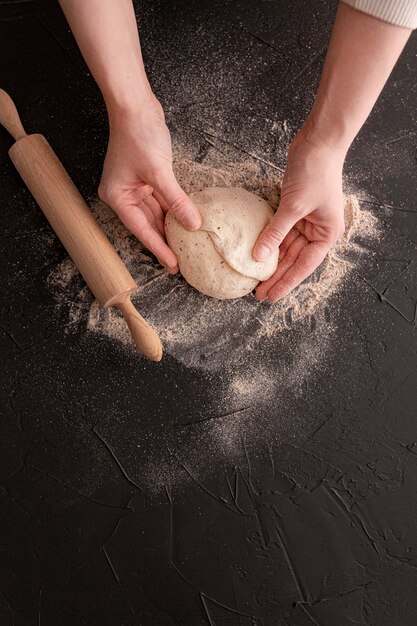 Close-up hands holding dough