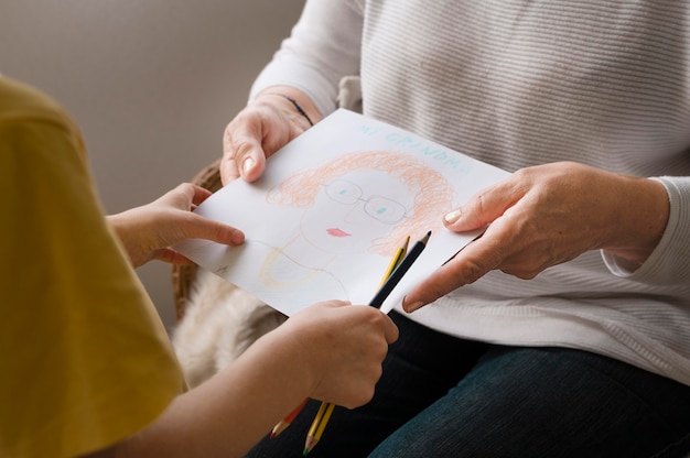 Free photo close up hands holding drawing