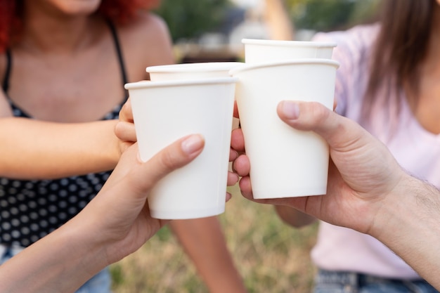 Close up hands holding drinks