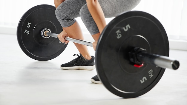 Close-up hands holding dumbbells bar