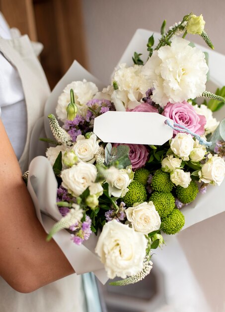 Close up hands holding flowers bouquet
