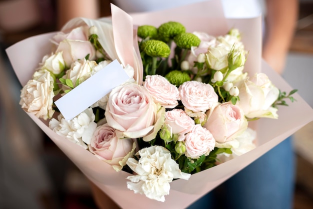 Close up hands holding flowers bouquet