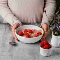 Free photo close-up hands holding food bowl