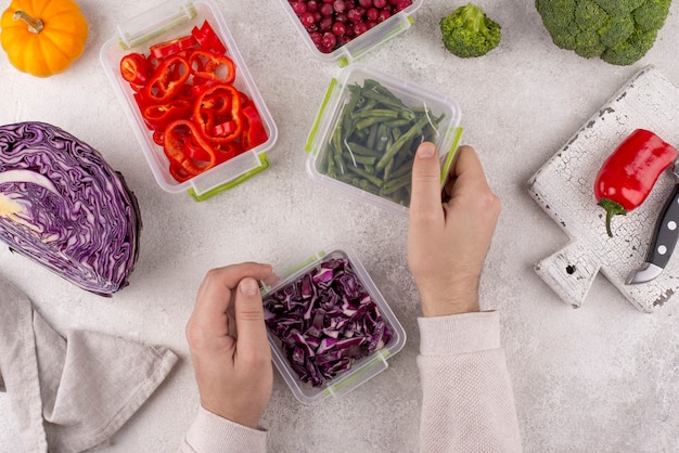 Close up hands holding food containers