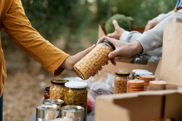 Free photo close up hands holding food jar