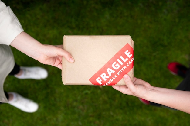 Close up hands holding fragile pack