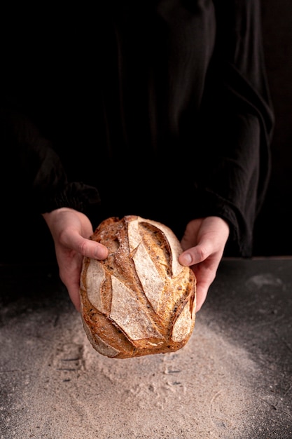 Free photo close-up hands holding fresh bread