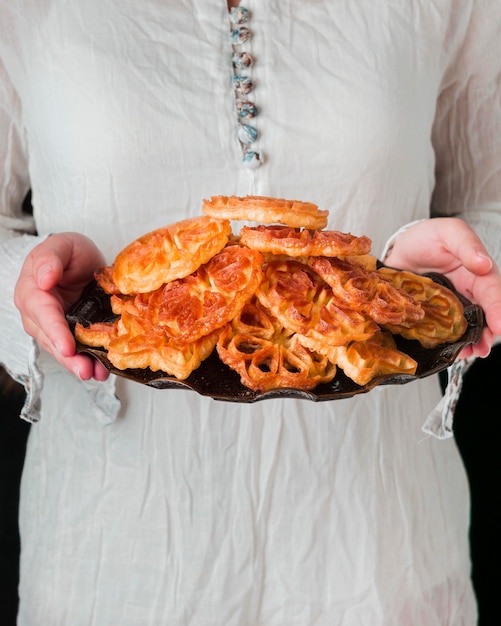 Close-up hands holding full plate