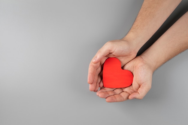 Close up hands holding heart