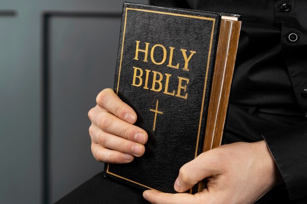 Close up hands holding holy bible