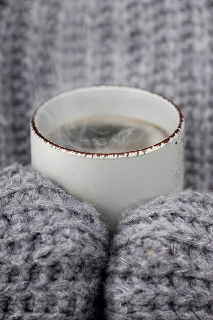 Close up hands holding hot drinks