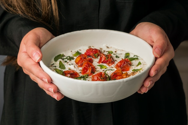 Close-up hands holding indian food bowl