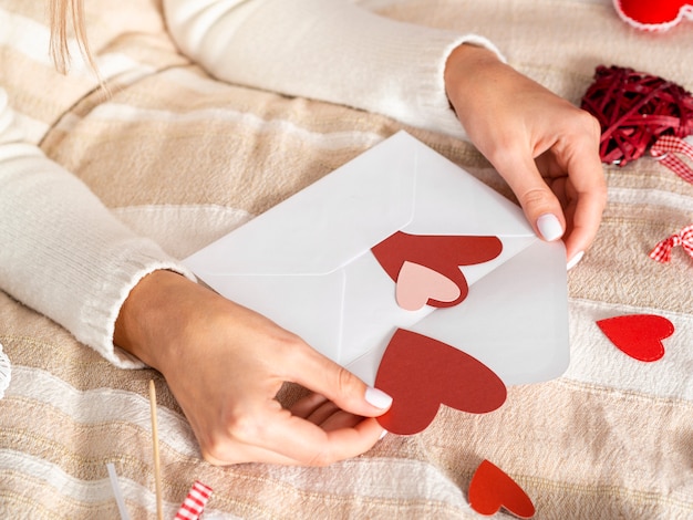 Close up hands holding love envelope