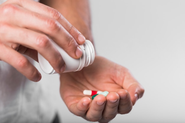 Free photo close-up hands holding medical capsules