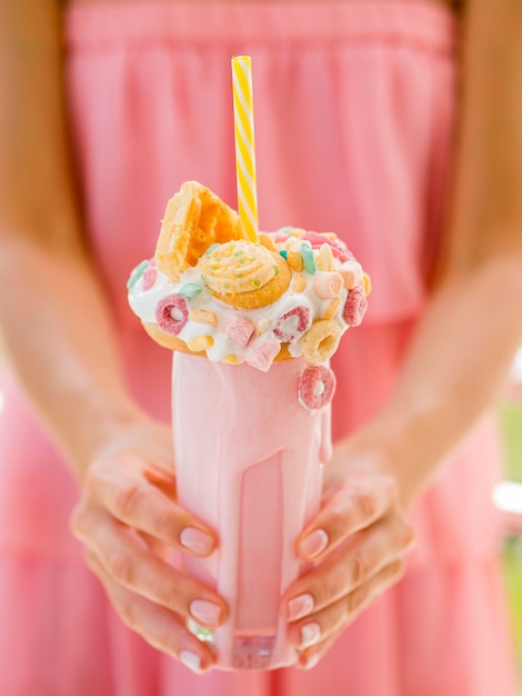 Close-up hands holding milkshake