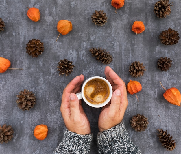 Free photo close-up hands holding mug with coffee