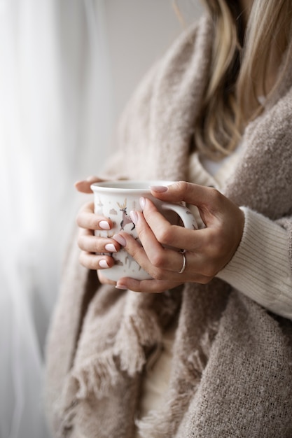 Close up hands holding mug