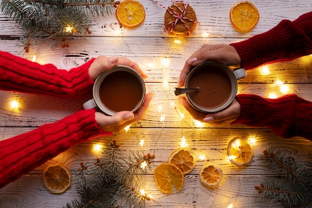 Close up hands holding mugs