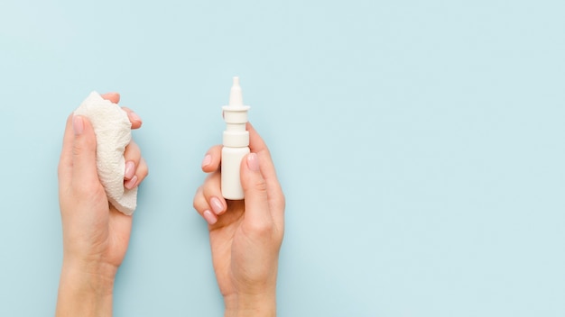 Close-up hands holding nasal spray