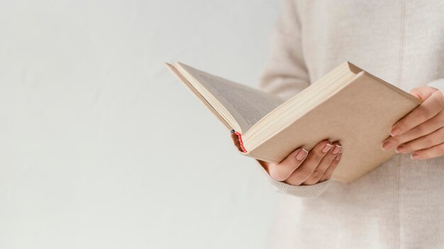 Close up hands holding open book Free Photo