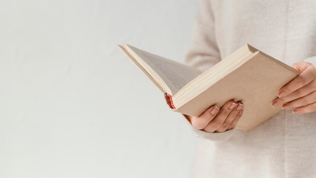 Close up hands holding open book