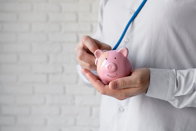 Close up hands holding piggy bank