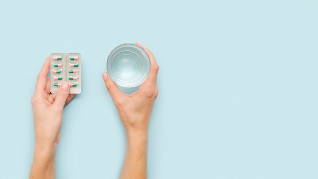 Close-up hands holding pills