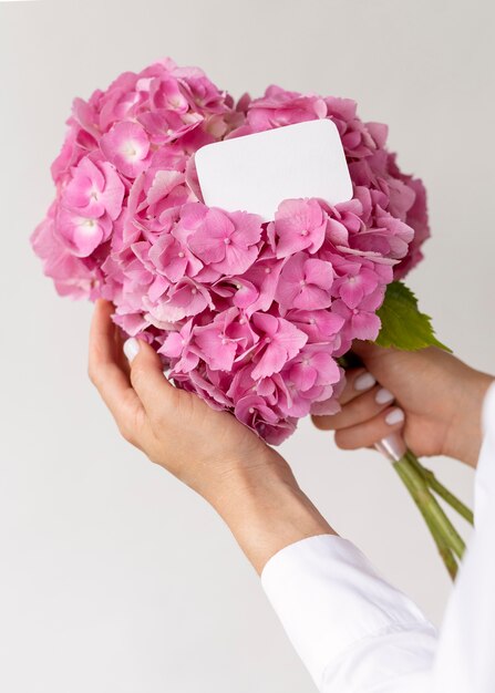 Close up hands holding pink hydrangea bouquet