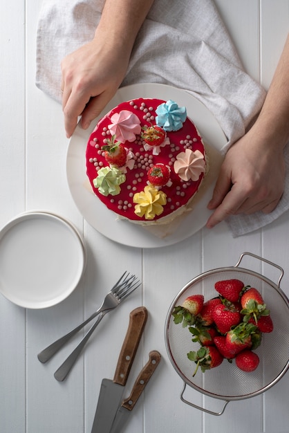 Free photo close up hands holding plate with cake