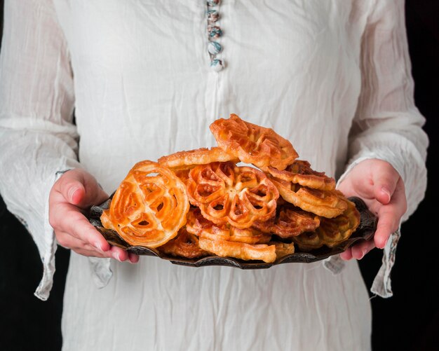 Free photo close-up hands holding plate with food