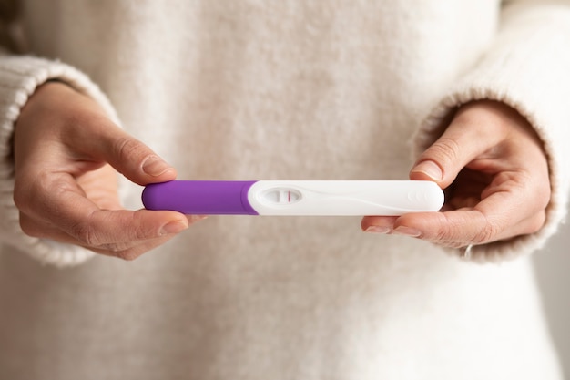 Close up hands holding pregnancy test
