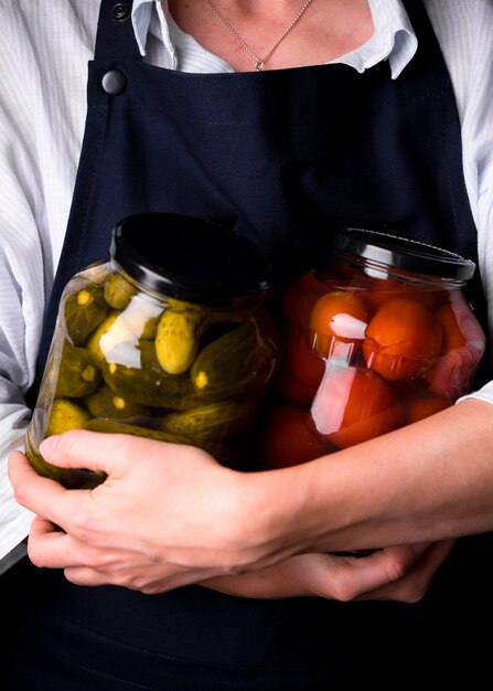 close-up hands holding preserves