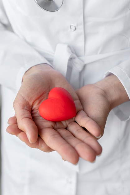 Close up hands holding red heart