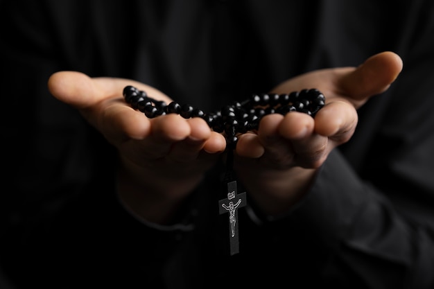 Close up hands holding rosary